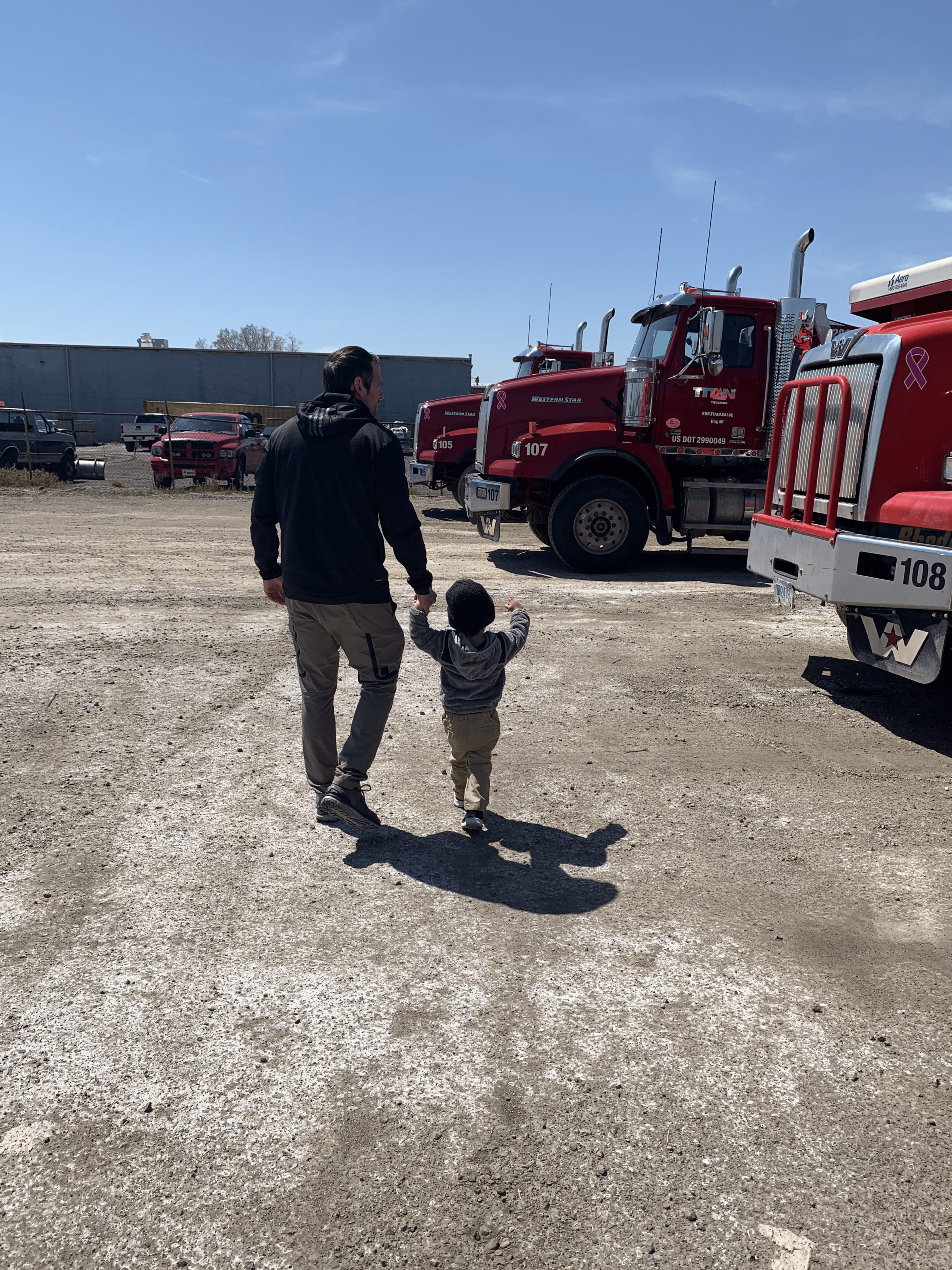 Jeff Riizzo and son, walking in the Truck yard at Titan.