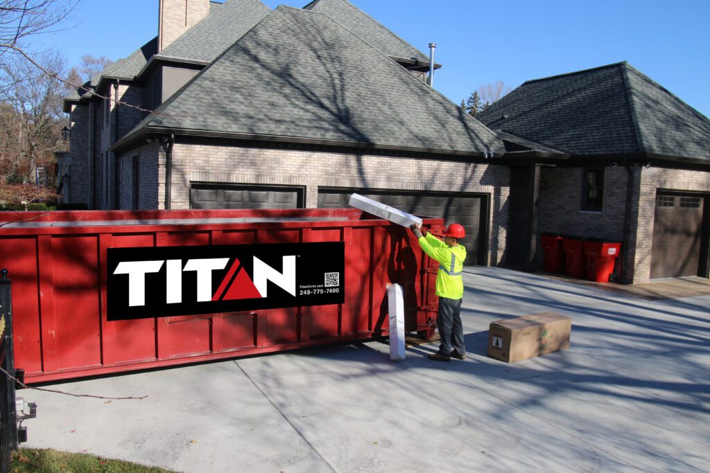 Red Titan Dumpster in a driveway.